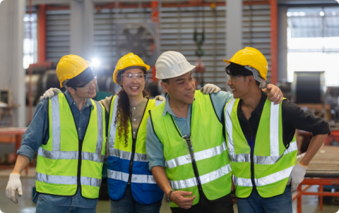 Healthy, diverse team of workers in an industrial setting